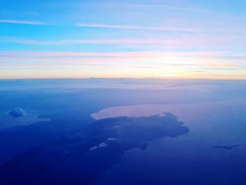 Aerial view of sea against sky during sunset