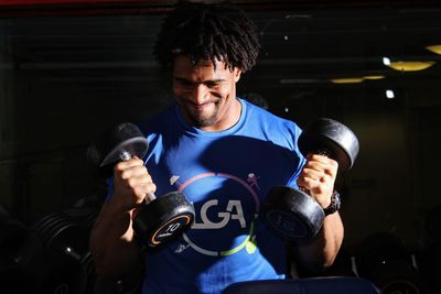 Young man lifting dumbbells in gym