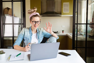 Woman talking on video call at home