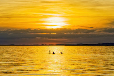 Scenic view of sea against orange sky