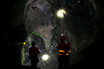 Rear view of friends in cave