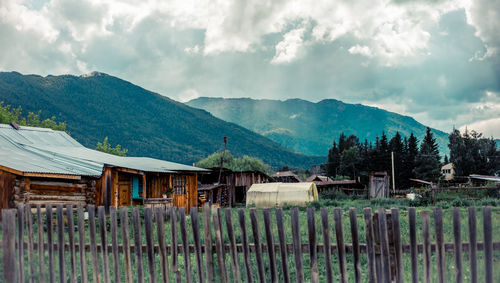 Panoramic shot of house and mountains against sky