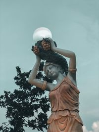 Low angle view of statue against sky