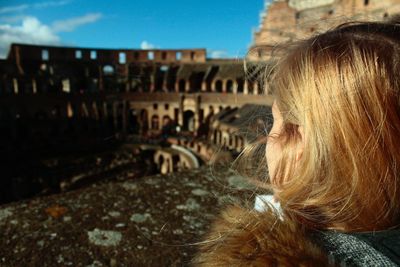 Cropped woman overlooking ruined structure