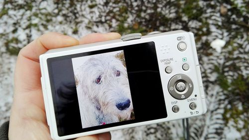 Close-up of camera photographing with mobile phone