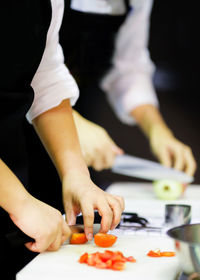 Midsection of person preparing food on table