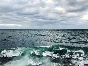 Scenic view of sea against cloudy sky