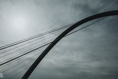 Low angle view of silhouette bridge against sky