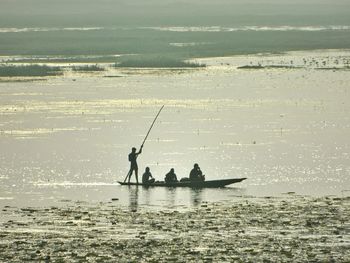 People in boat on lake