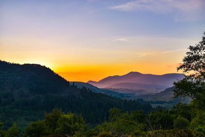 Scenic view of mountains against sky during sunset