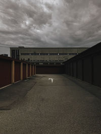Empty road against cloudy sky