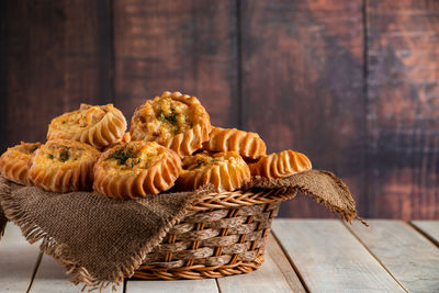 Close-up of pine cone on wicker basket on table