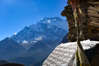 Scenic view of snowcapped mountains against clear blue sky