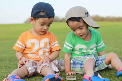 Boy friends on grassy landscape