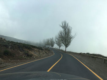 Empty road along countryside landscape