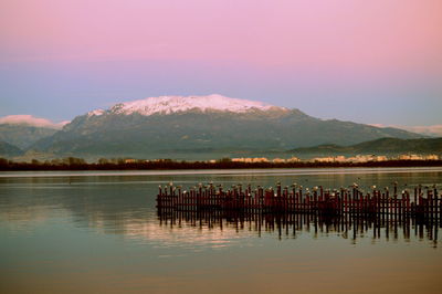 Scenic view of lake against mountains during sunset