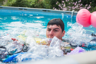 Portrait of man swimming in pool