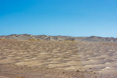 View of desert against blue sky