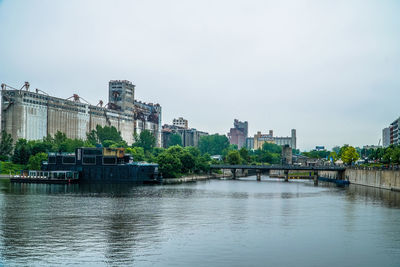 River in city against clear sky