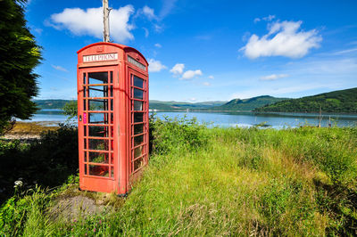 Lifeguard hut on land against sky