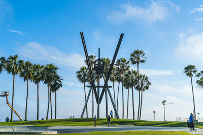 Panoramic view of palm trees against sky