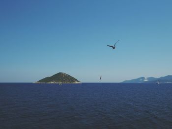 Scenic view of sea against clear blue sky