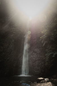 Scenic view of waterfall against sky