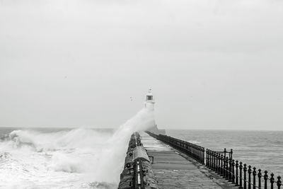 Pier over sea against  waves