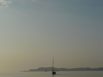 Sailboat in sea against clear sky