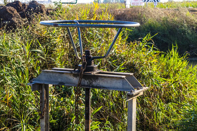 Close-up of machine part on field