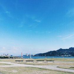 Scenic view of beach against blue sky