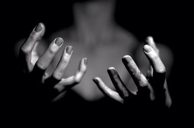 Close-up of hands over black background