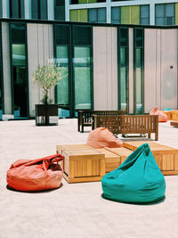 Table and chairs against building in city