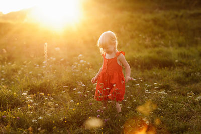 Full length of child on field during sunset