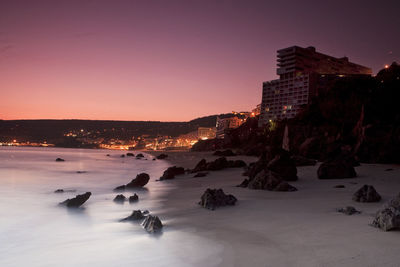 High angle view of illuminated buildings against sky during sunset