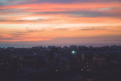 High angle view of illuminated buildings against sky during sunset