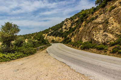 Road amidst mountains against sky