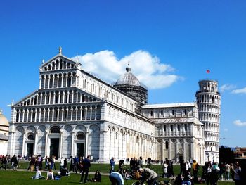 People at piazza dei miracoli against blue sky