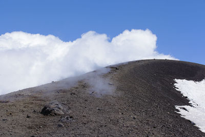Scenic view of volcanic mountain against sky
