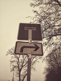 Low angle view of information sign against sky