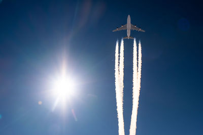 Low angle view of airplane flying against sky