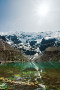 Laguna humantay with snow covered mountains in the background