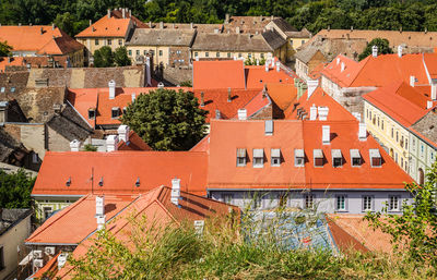 Roofs of houses, covered with old tiles with dilapidated chimneys.