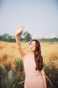 Young woman with long hair standing on land