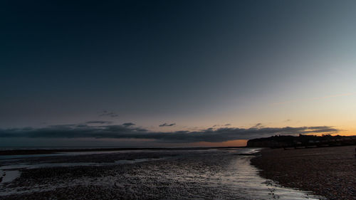 View of calm beach at sunset