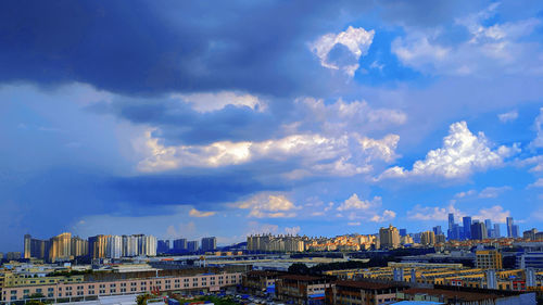 Panoramic view of buildings in city against sky