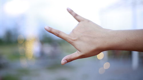 Cropped hand gesturing outdoors