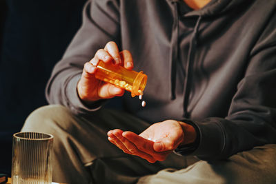 Midsection of man holding electronic cigarette