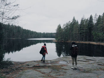 Full length of woman standing by lake