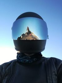 Reflection of cityscape in motorcycle helmet